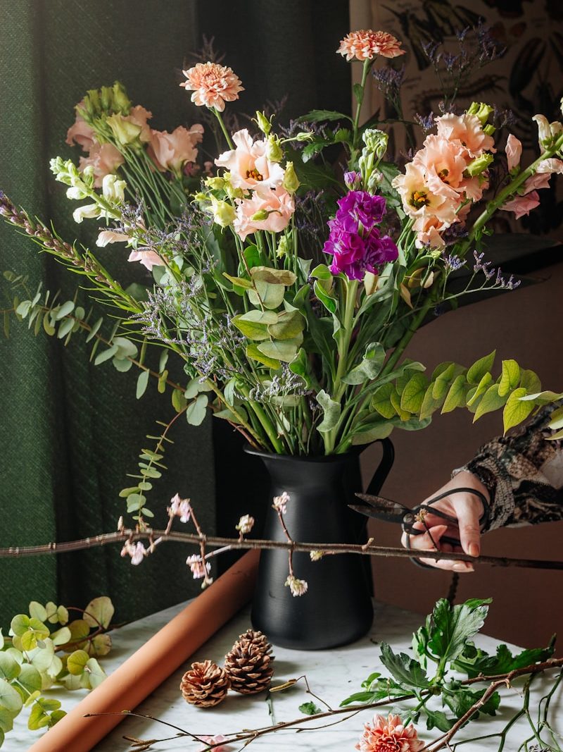 white and purple flowers in black vase